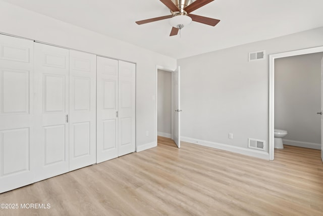 unfurnished bedroom with visible vents, a closet, and light wood finished floors