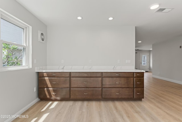 unfurnished room with baseboards, visible vents, and light wood-style flooring