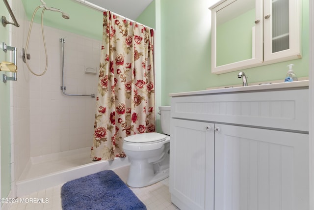 bathroom with tile patterned flooring, toilet, vanity, and a stall shower