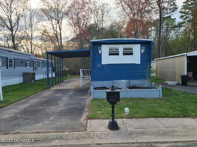 28 Alissa Ter, Jackson, NJ 08527 - view of front of property with cooling unit, driveway, a front yard, and an attached carport