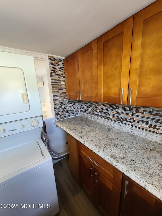28 Alissa Ter, Jackson, NJ 08527 - laundry room featuring stacked washer / drying machine, dark wood-style floors, and laundry area