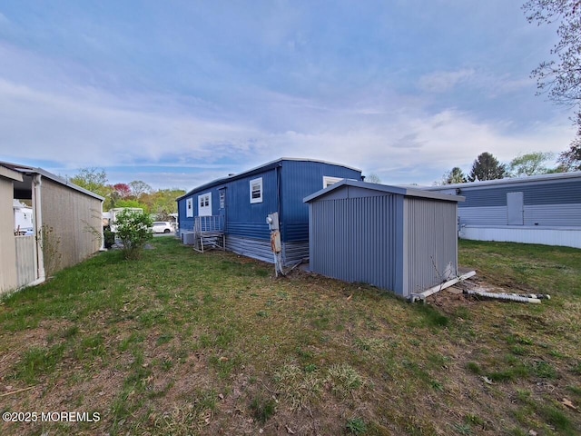 28 Alissa Ter, Jackson, NJ 08527 - rear view of house with a storage shed, an outbuilding, and a yard