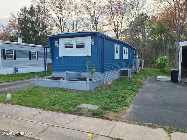 28 Alissa Ter, Jackson, NJ 08527 - view of front facade with cooling unit and a front lawn