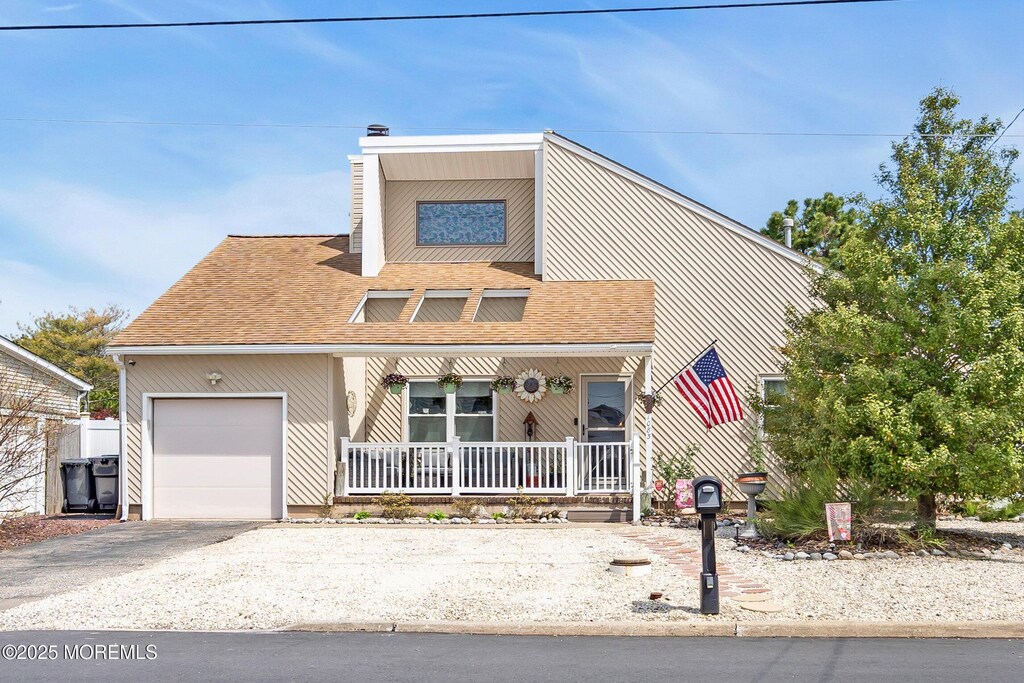 1083 Walter Blvd, Manahawkin, NJ 08050 - view of front of house with a chimney, a porch, a shingled roof, and an attached garage