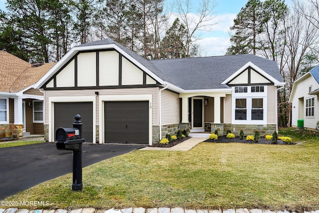 view of front of house featuring driveway, a front lawn, and a garage