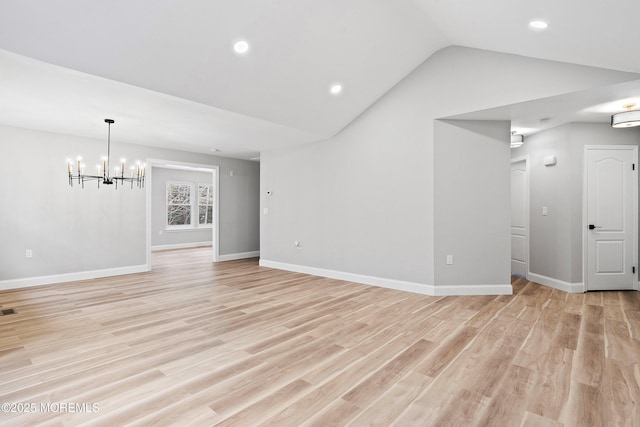 unfurnished living room with vaulted ceiling, baseboards, light wood finished floors, a notable chandelier, and recessed lighting