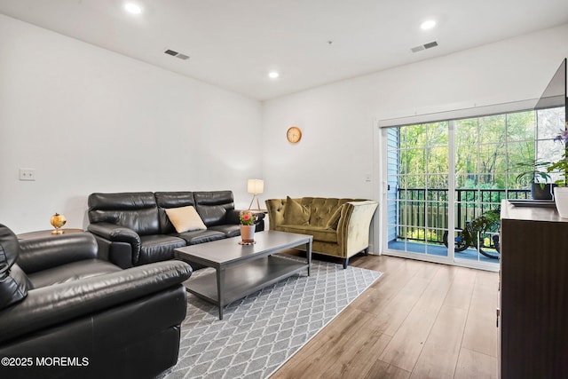 living room featuring recessed lighting, visible vents, and wood finished floors
