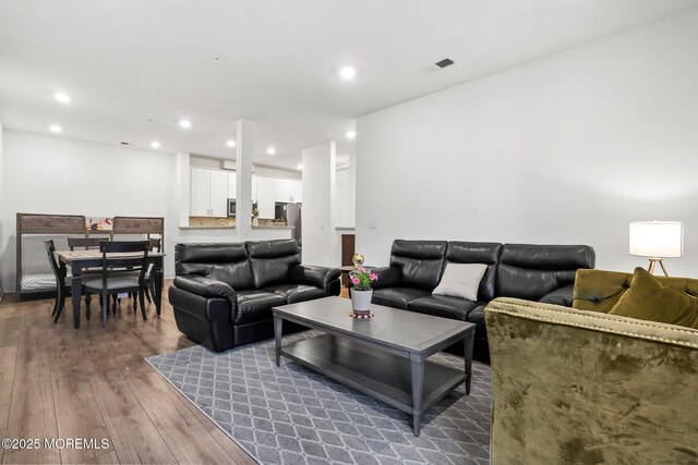 living room featuring recessed lighting and wood finished floors