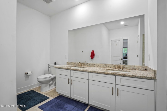 full bath featuring a sink, tile patterned flooring, toilet, and double vanity