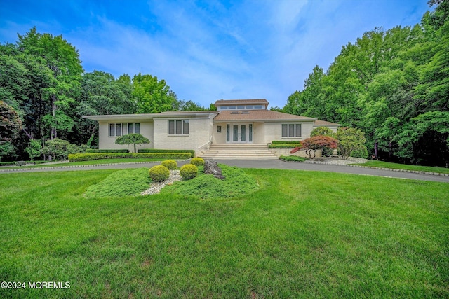 44 Nikki Ct, Morganville, NJ 07751 - single story home with a front lawn, french doors, and aphalt driveway