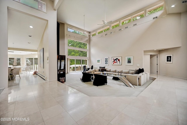 44 Nikki Ct, Morganville, NJ 07751 - living area featuring a towering ceiling, ceiling fan, tile patterned floors, and plenty of natural light
