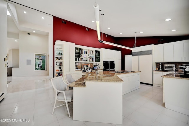 44 Nikki Ct, Morganville, NJ 07751 - kitchen with recessed lighting, gas stovetop, built in fridge, a sink, and a towering ceiling