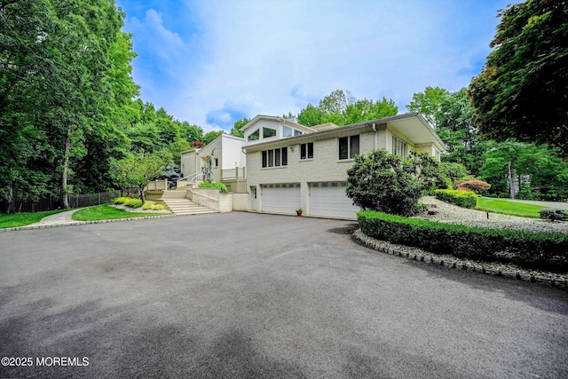 44 Nikki Ct, Morganville, NJ 07751 - bi-level home with driveway, brick siding, and a garage