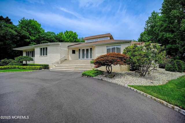 44 Nikki Ct, Morganville, NJ 07751 - view of front of property featuring aphalt driveway, french doors, and brick siding
