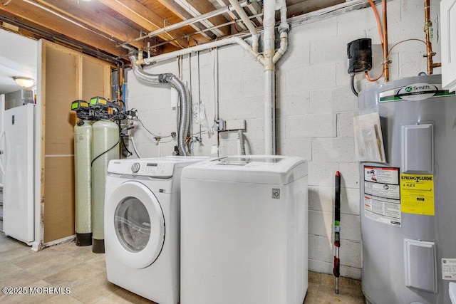 washroom with washer and dryer, electric water heater, concrete block wall, and laundry area