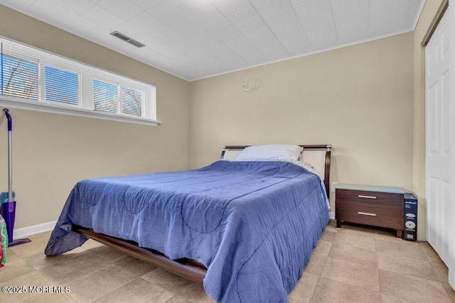 bedroom featuring ornamental molding and visible vents