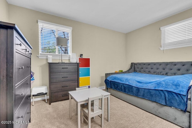 carpeted bedroom featuring baseboards