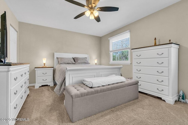 bedroom featuring baseboards, a ceiling fan, and light carpet