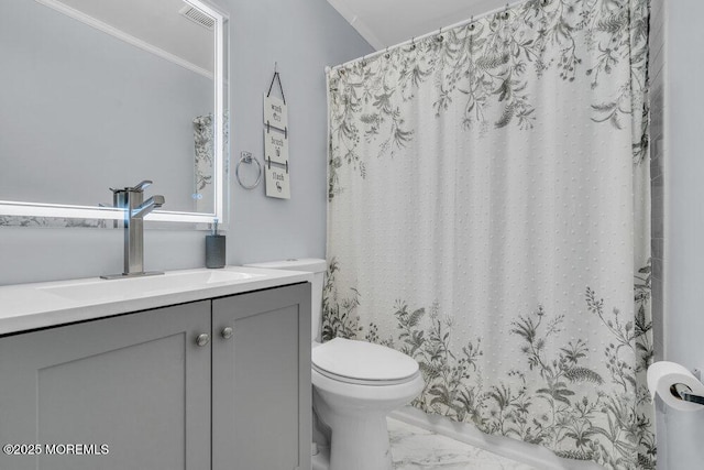 full bathroom featuring marble finish floor, toilet, vanity, curtained shower, and crown molding