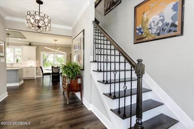 136 Lilac Dr, Brick, NJ 08724 - stairway with an inviting chandelier, ornamental molding, baseboards, and wood finished floors