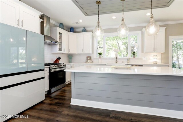 136 Lilac Dr, Brick, NJ 08724 - kitchen featuring ornamental molding, stainless steel gas range oven, wall chimney exhaust hood, white cabinetry, and tasteful backsplash