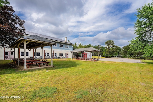 back of house with a gazebo and a yard