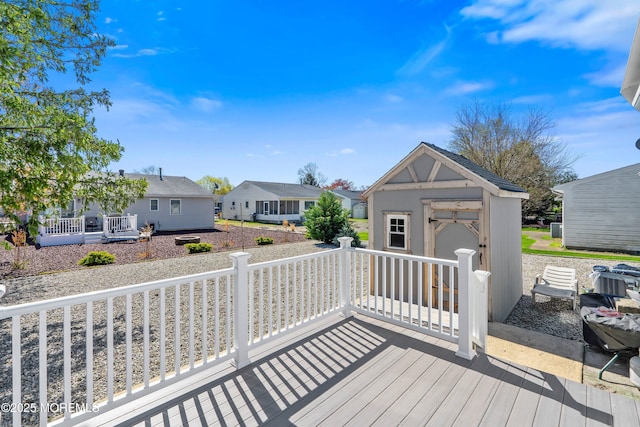deck with a residential view and an outbuilding