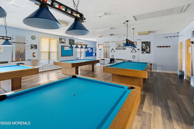 rec room with baseboard heating, wood finished floors, a textured ceiling, and billiards