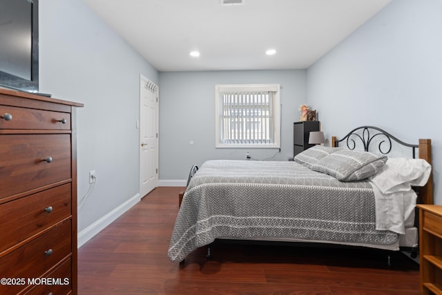 bedroom with baseboards, recessed lighting, and dark wood finished floors
