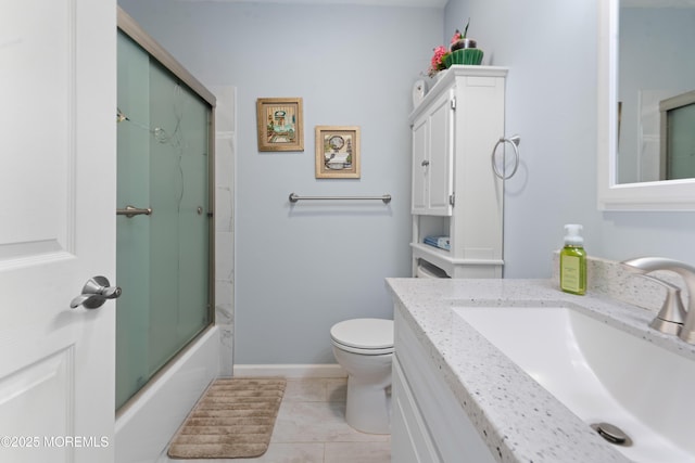 full bath with bath / shower combo with glass door, toilet, baseboards, tile patterned flooring, and vanity