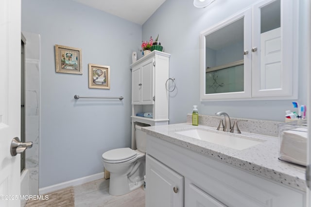 full bathroom with toilet, vanity, and baseboards