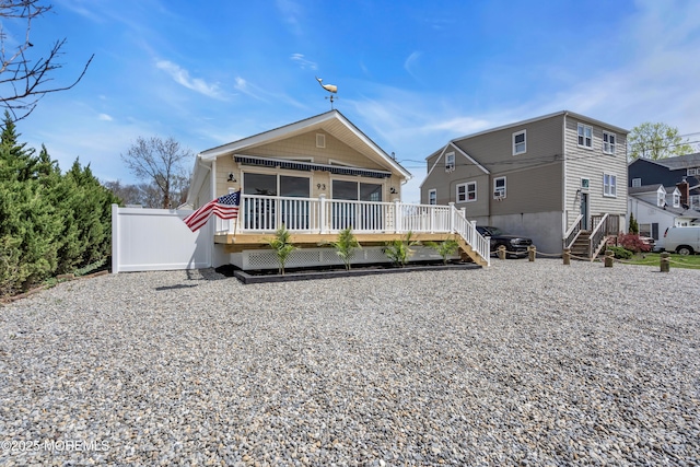 view of front of home with a deck and stairway
