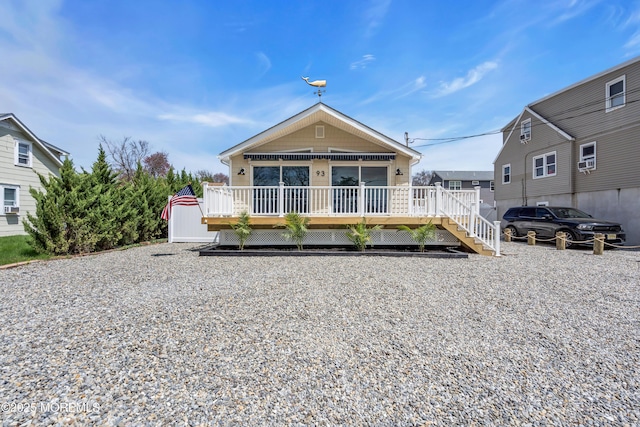 rear view of house featuring a wooden deck
