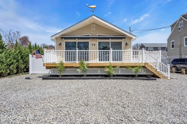 view of front of house featuring a wooden deck and stairs