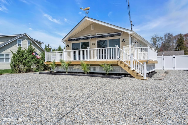 view of front of home featuring a wooden deck, fence, and a gate