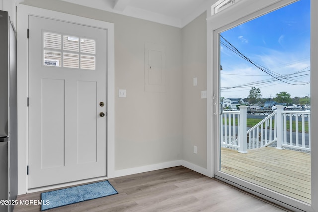 foyer featuring baseboards and light wood-style floors