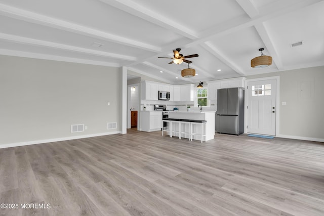 unfurnished living room with visible vents, a ceiling fan, light wood-style flooring, and baseboards