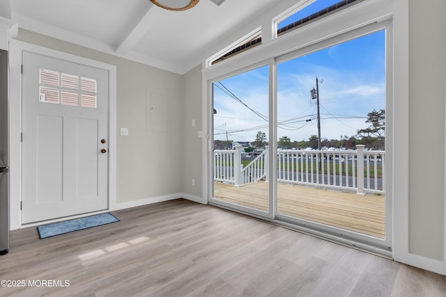 entryway with baseboards, light wood-type flooring, and beamed ceiling