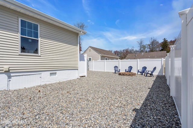 view of yard with a fire pit and a fenced backyard