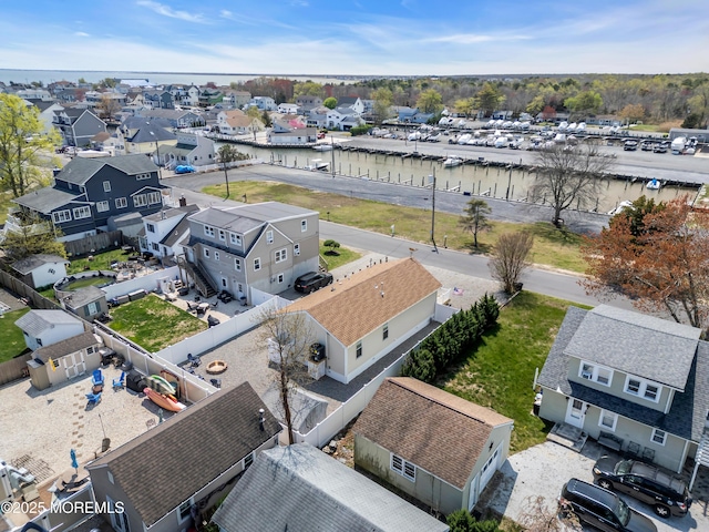 birds eye view of property with a water view and a residential view