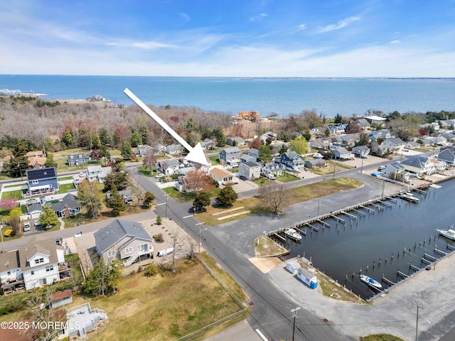 drone / aerial view featuring a residential view and a water view