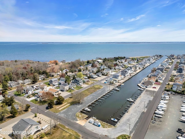 drone / aerial view featuring a water view and a residential view