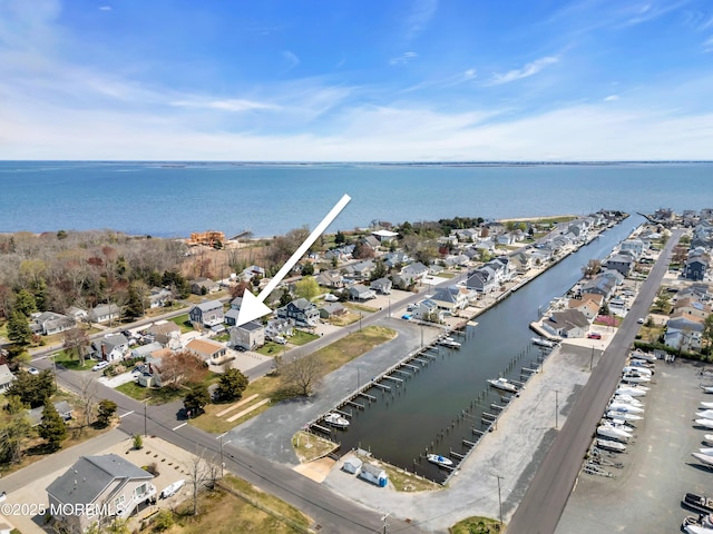 bird's eye view featuring a water view and a residential view