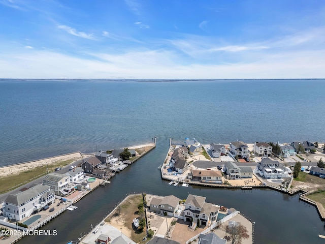 drone / aerial view with a residential view and a water view