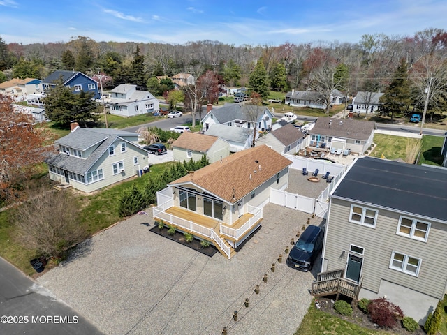 drone / aerial view with a wooded view and a residential view