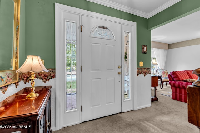 foyer entrance with crown molding and carpet