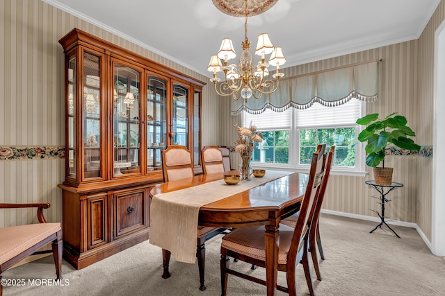 dining room with crown molding, a notable chandelier, wallpapered walls, and light colored carpet