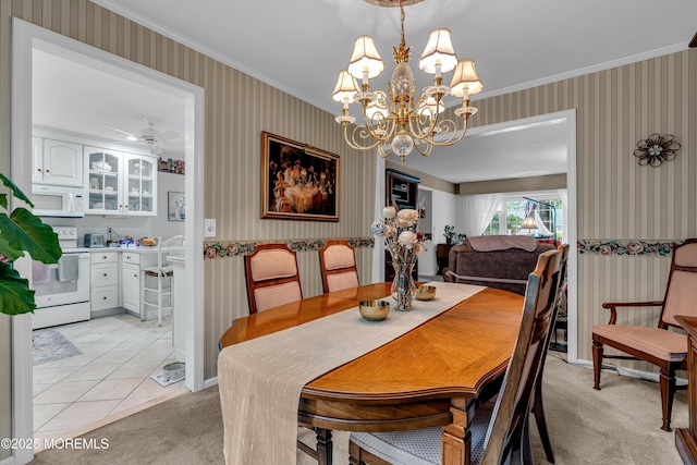 dining area featuring crown molding, baseboards, wallpapered walls, and light colored carpet