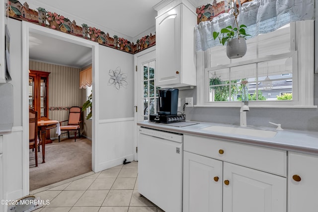 kitchen with light countertops, white cabinets, light carpet, and dishwasher