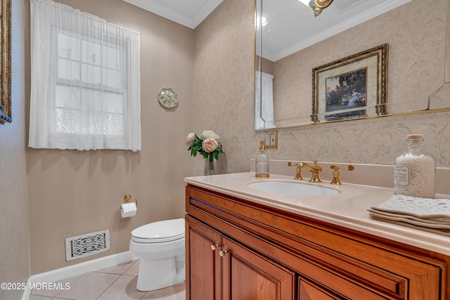 half bath with visible vents, ornamental molding, toilet, baseboards, and tile patterned floors